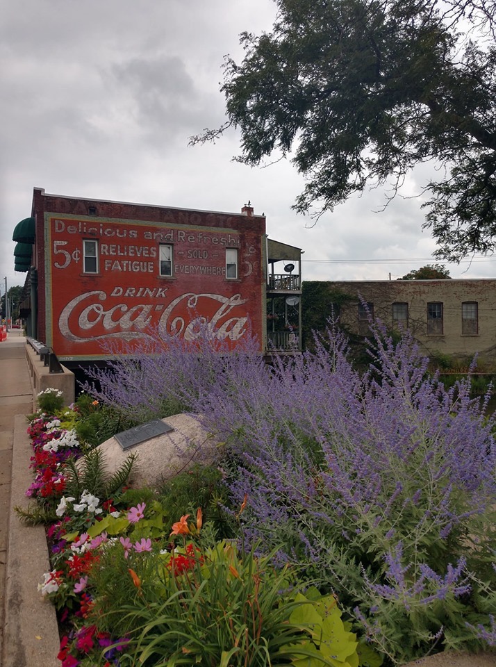 View of Coca-Cola mural building with marker in front